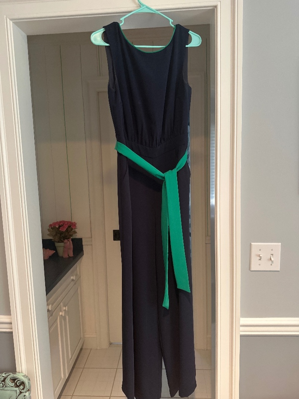 Navy blue jumpsuit with green trim